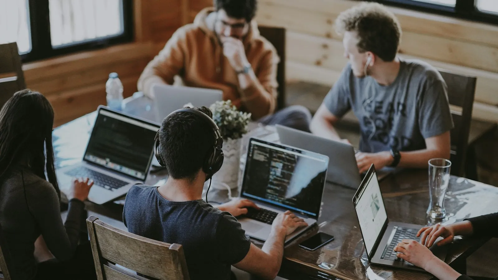Team working together around a table with laptops