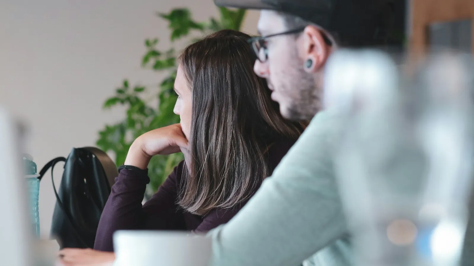Two people reviewing an interface on a screen together