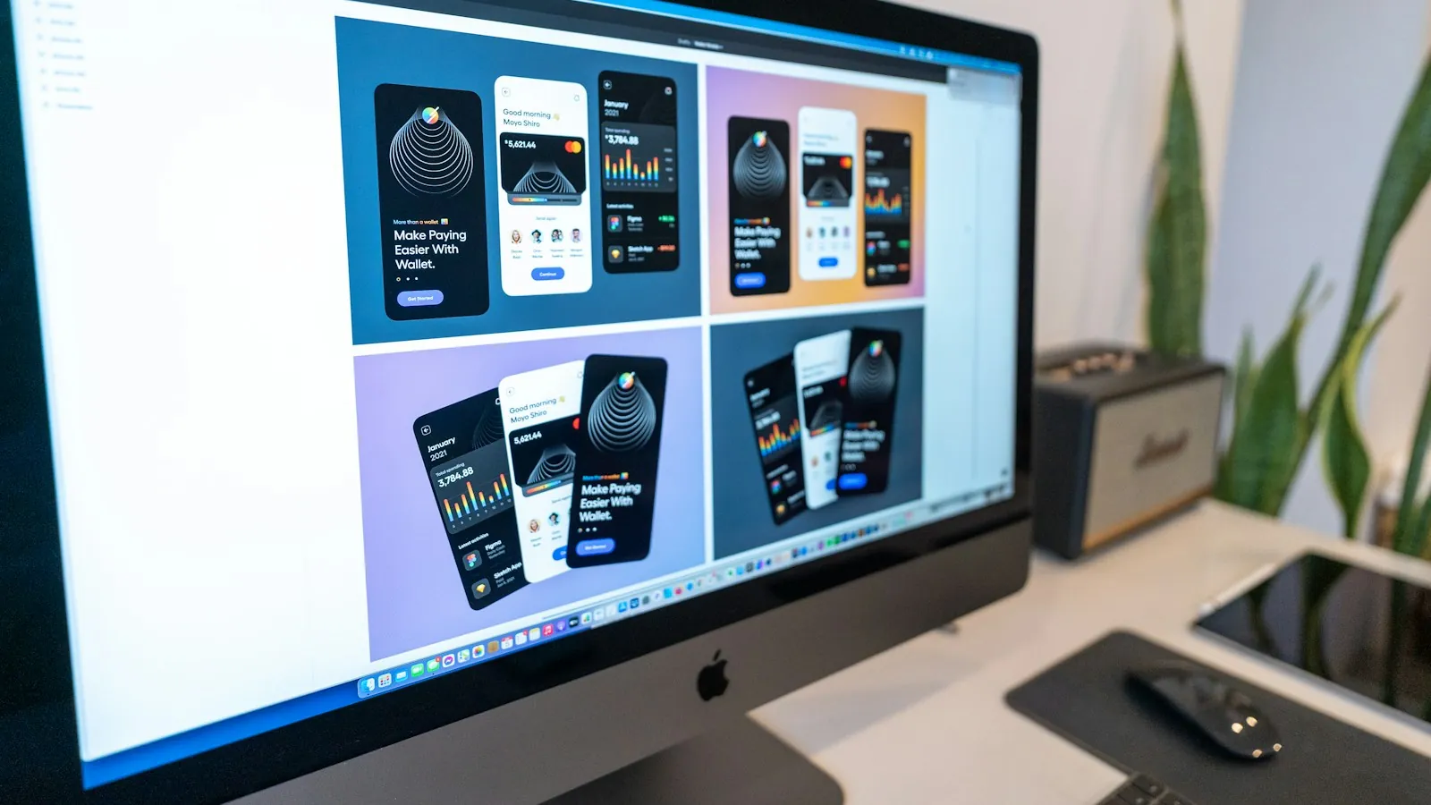 Monitor displaying several mobile app interface designs