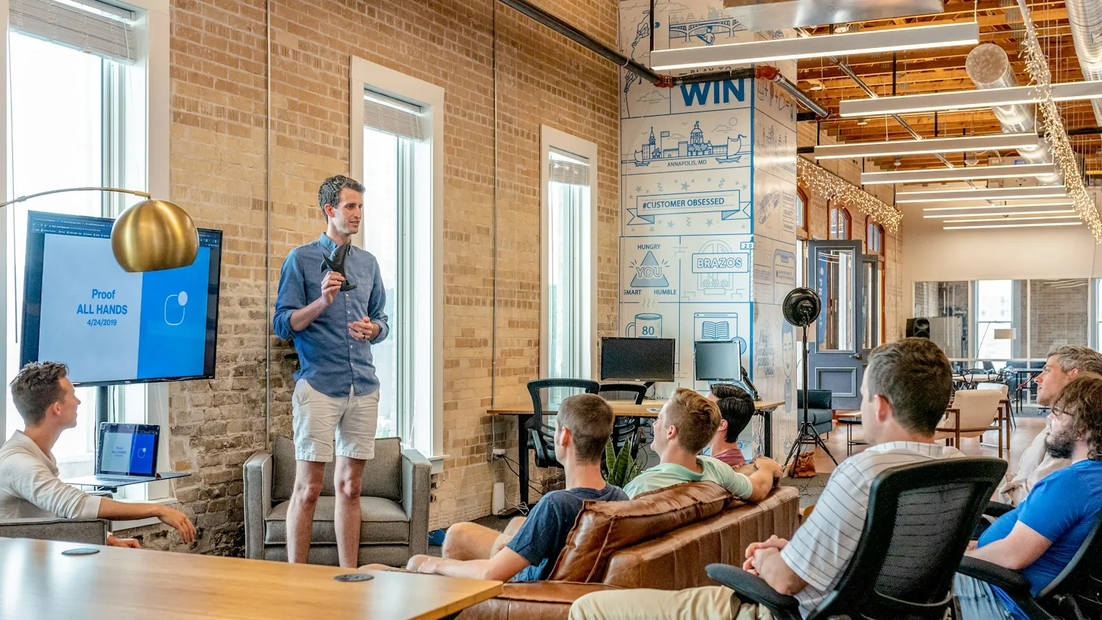 Presenter speaking to a team in a casual office meeting