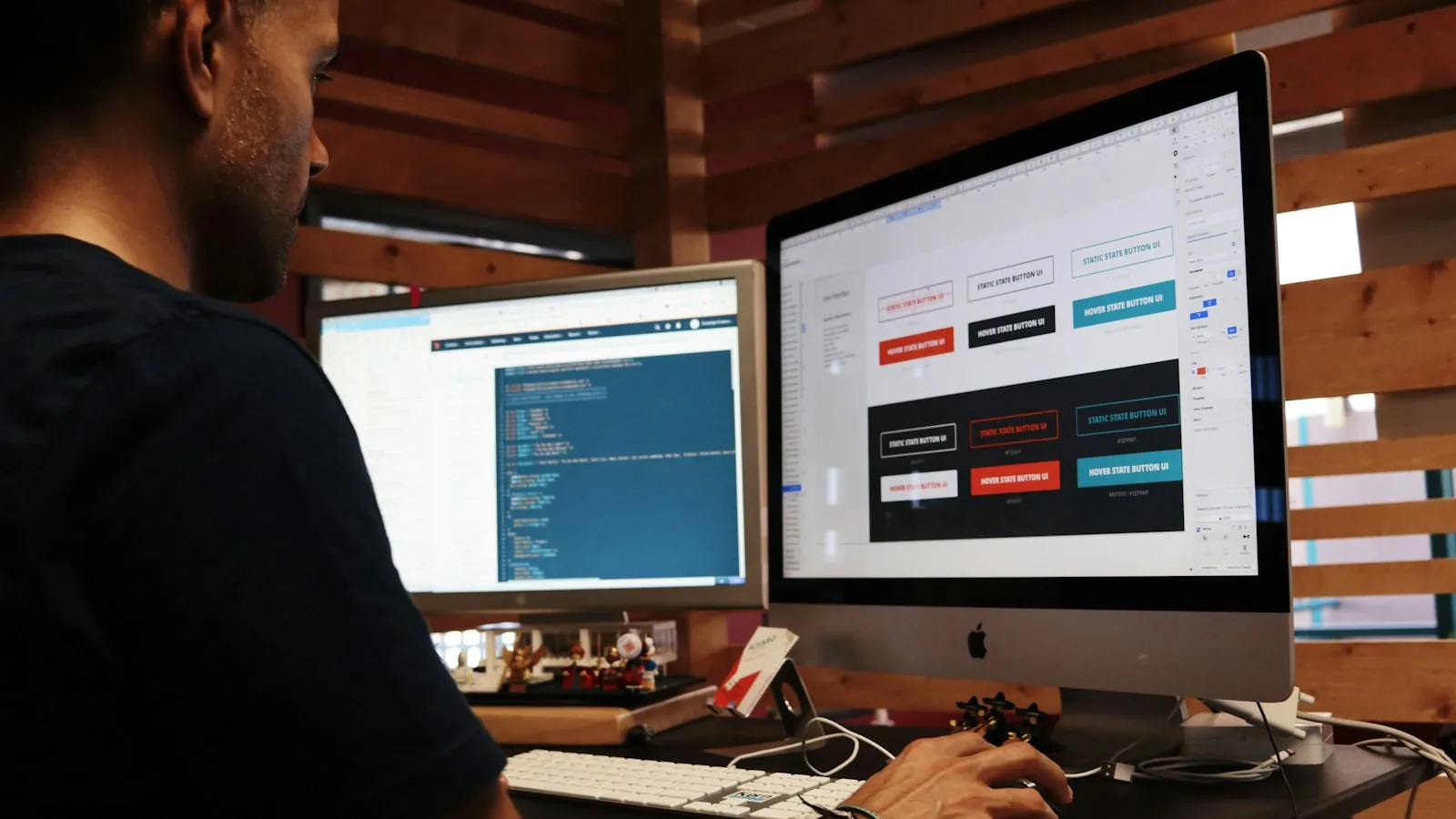 Designer working on user interface screens at a large monitor